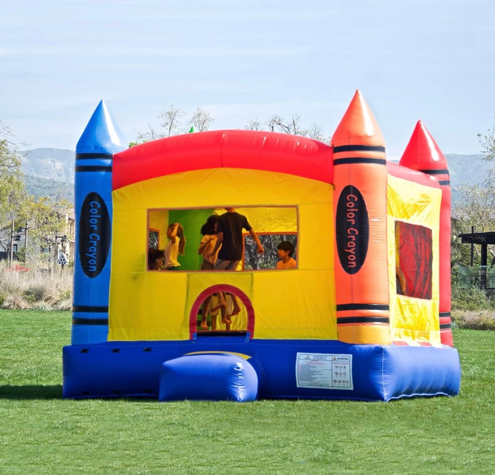 Kids having fun at a bounce house birthday party