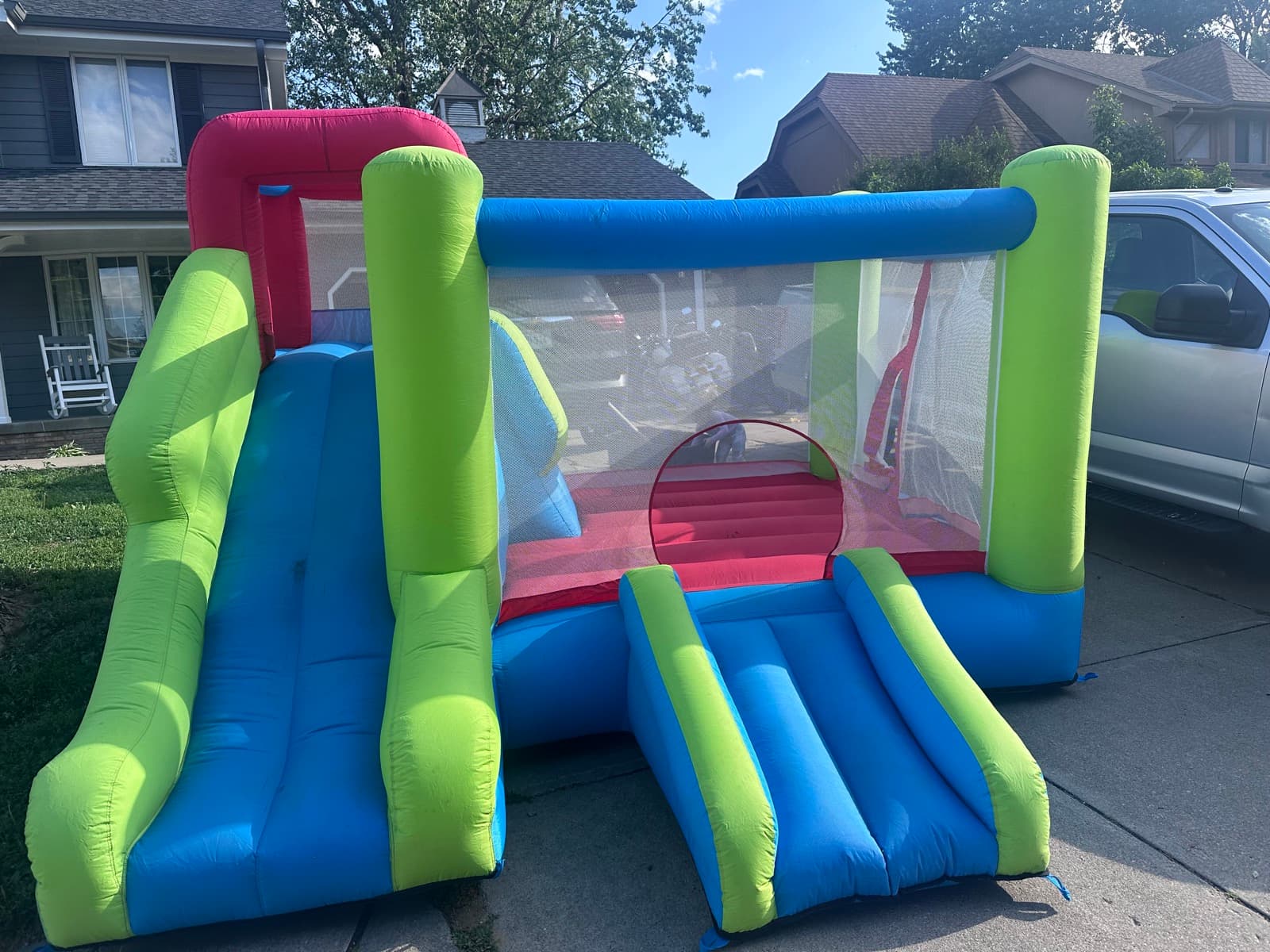 Blue and green combo bounce house with slide and basketball hoop for toddlers